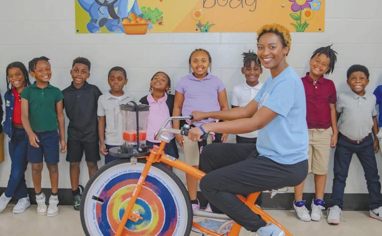 Lakeview Primary School teacher Jemeria Cummings and Aketi Mayweather pose with Donessa Bonner’s after-school STEAM Class. CONTRIBUTED