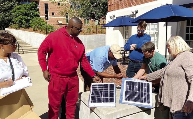 Members of the business/solar course inspected solar panels last spring at Georgia College &amp; State University. COURTESY OF GCSU