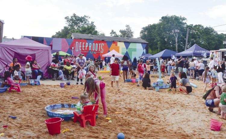First Friday Beach Bash was full of visitors to Milledgeville’s mini beach in the parking lot of the Deep Roots stage area. Made from 80 tons of sand, the beach was littered with nets, balls, and pools for water and sandy activities.