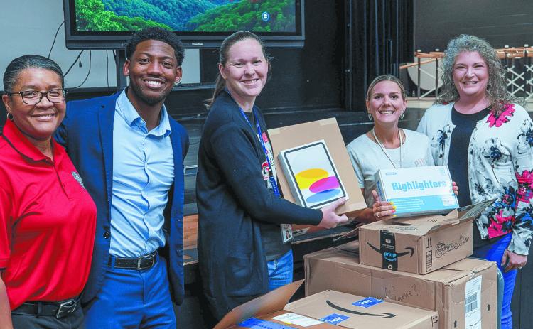 Robins Financial’s Hillary Bobbitt and Kamal McKenzie deliver educational equipment to Baldwin High School grant winners Alicia Johnson and Kristin Grebel, along with Principal Markeeta Clayton. CONTRIBUTED