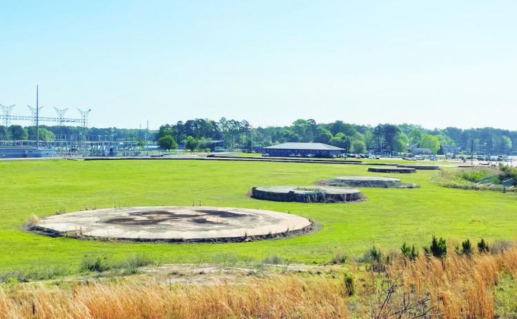 All that’s left of the once-mighty, 1,007-feet-tall smokestack that towered over Plant Branch is a circular concrete base in an open field. Built in 1978, the smokestack was dropped in a controlled demolition on Oct. 15, 2016. COURTESY GEORGIA POWER
