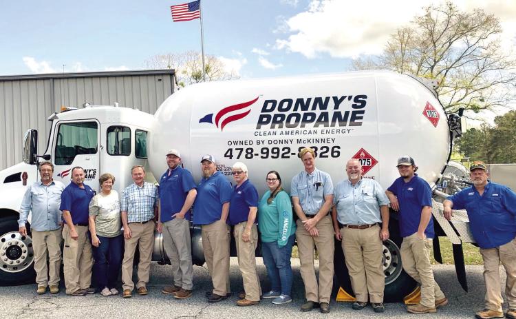 Donny’s Propane employees gather around one of the propane trucks for a photo at the company. ADAM SEGERS/Contributed