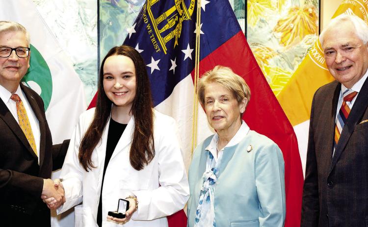 L-R: Jim Fortenberry, M.D., chief medical Officer, children’s; Addison Clark; Jean Sumner, M.D., FACP, dean of Mercer University School of Medicine, and William D. Underwood, president of Mercer University, poses during the honor ceremony. CONTRIBUTED