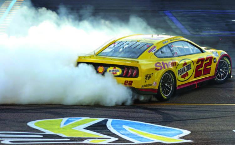 Joey Logano, driver of the #22 Shell Pennzoil Ford, celebrates with a burnout after winning the 2022 NASCAR Cup Series Championship at Phoenix Raceway Images) Sunday. (Christian Petersen/Getty Images)
