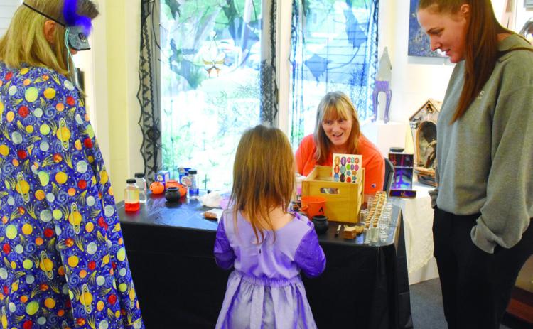 Participants dressed up at the Haunted Milledgeville reception and joined together in making potion souvenirs to take home. BAILEY BALLARD/Staff