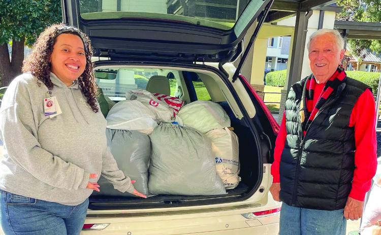 Georgia War Veterans Home Activities Director Michelle Flood accepts clothes donated by the Lake Oconee Elks clothing drive from Lake Oconee Veterans Chairman Mike DePetrillo. CONTRIBUTED