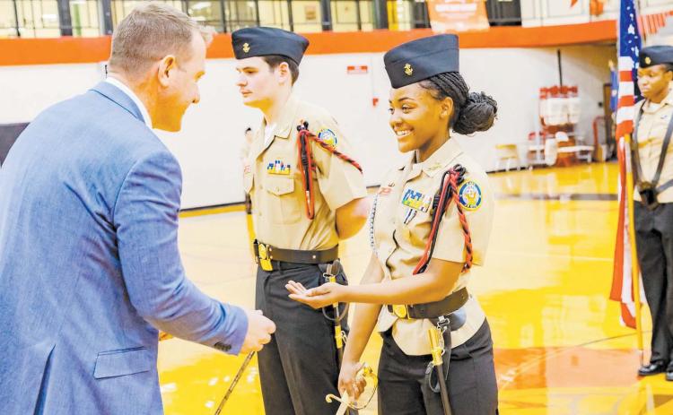 Dr. Matthew Jordan (left), NJROTC Area Nine manager, presents Baldwin High School NJROTC student cadet leaders Deasia Hurt (right), and Ethan Tavares (middle), with an award during the unit’s annual pass-inreview ceremony in the James A. Lunsford Gymnasium. CONTRIBUTED