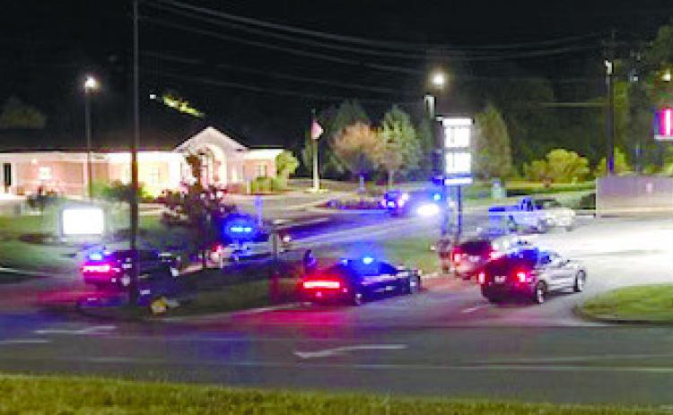 Law enforcement officers set up a perimeter around a scene where suspects were seen running away behind Murphy USA in Milledgeville Saturday morning. JEFF LYLE/Staff