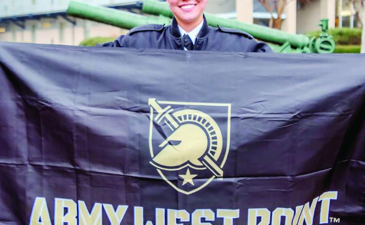 Grace Houghton proudly hosts the banner of Army West Point as a representation of her acceptance. COURTESY OF GMC