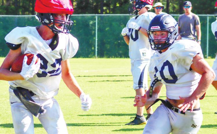 The Trojans put on their pads for the first time this season following the acclimation period. LANCE McCURLEY/Staff