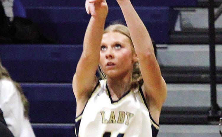 Lady Trojan junior Lucy Elliott (11) tosses up a 3-pointer. TREY NORRIS/Staff
