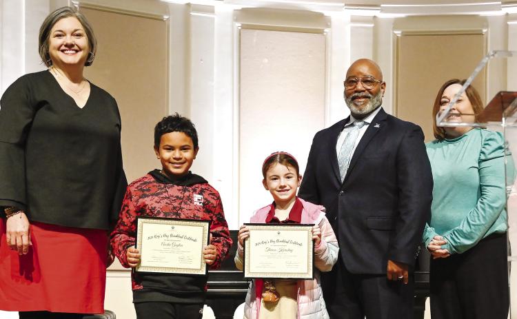 Lakeview Primary students Austin Guyton and Theresa Karashay receive their certificates for winning the K-2 art contest. ANNA LEAVITT/Courtesy of GCSU