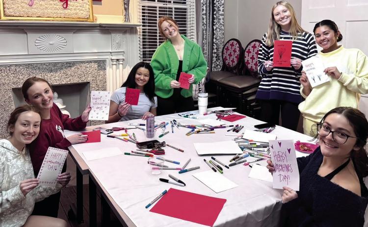 Members of Alpha Gamma Delta writing cards for the nursing home. AMELIE SENGUPTA/Staff