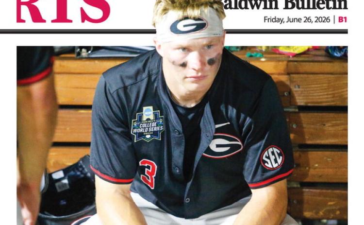 Georgia catcher Daniel Jackson sits in the dugout contemplating what might have been after the Bulldogs’ 11-4 loss to Oklahoma on June 17. LANCE McCURLEY/Staff
