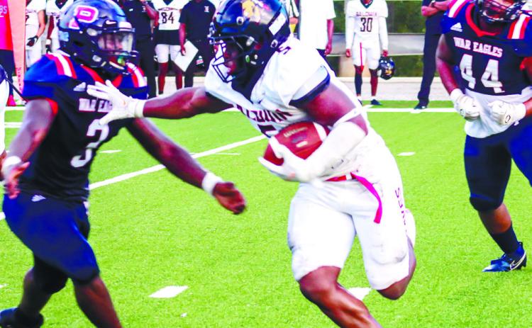 Baldwin running back Micah Welch (5) stiff arms a Putnam County player in last year's season opener. LANCE MCCURLEY/Staff