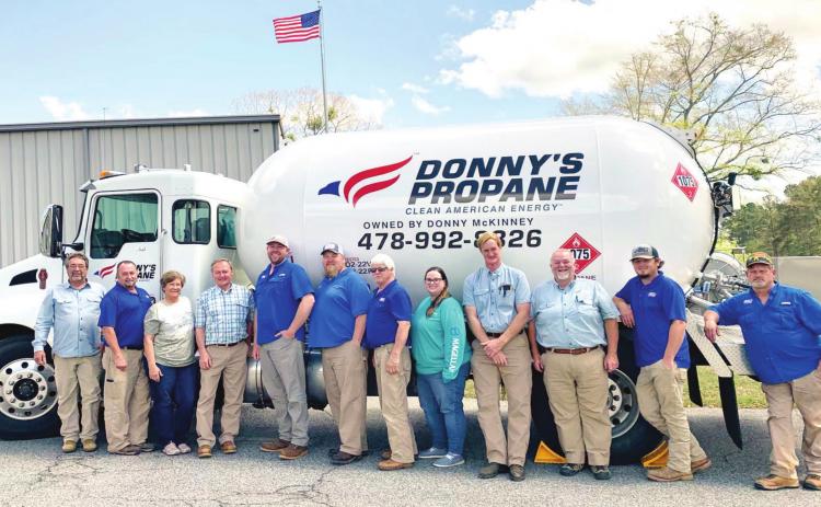 Donny’s Propane employees gather around one of the propane trucks for a photo at the company. ADAM SEGERS/Contributed