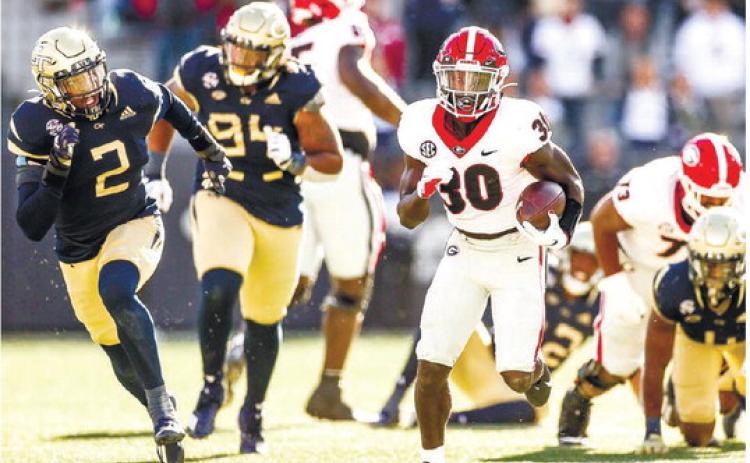 Georgia running back Daijun Edwards (30) creates separation from Georgia Tech defenders in 2021. TONY WALSH/UGA Athletics