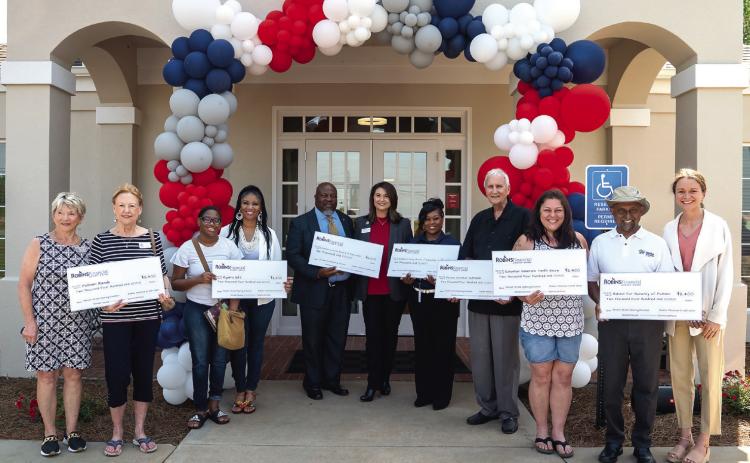 Christina O’Brien, president and CEO of Robins Financial Credit Union presented checks to seven local nonprofit organizations. CONTRIBUTED