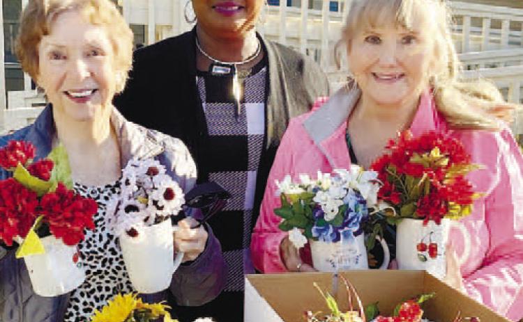 It was a magical day when Milledgeville Garden Club members met to make holiday flower arrangements for tenants to enjoy in their rooms at five Assisted Living Homes: Savannah Court, Chaplinwood, Cottages, Fellowship Home and Green Acres. Pictured making the delivery to Savannah Court’s Activity Director Sharon (center) are Sylvia Moore and Sharon Williams. “It’s always a blessing for MGC to do this annual holiday event” said Kathy Chandler, club President. CONTRIBUTED