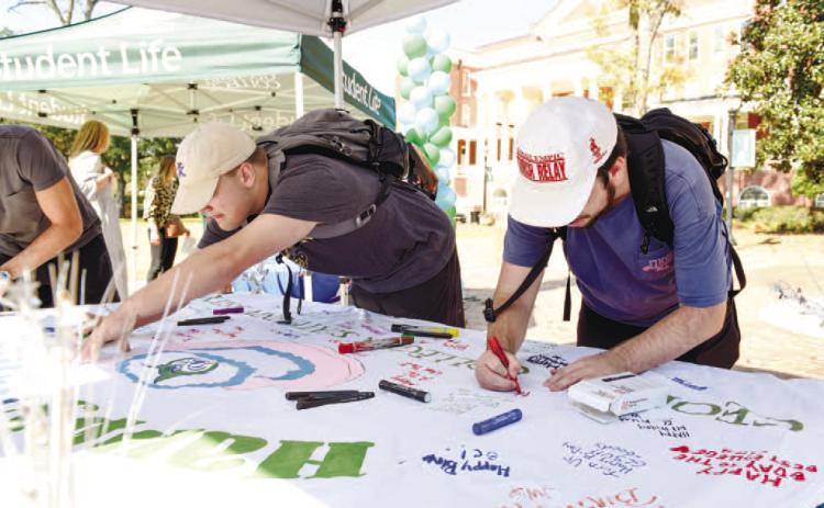 Students sign GCSU’s ‘birthday card’ that was created by senior Anna Kate Sweeney. MORGAN TICKERHOOF/Contributed