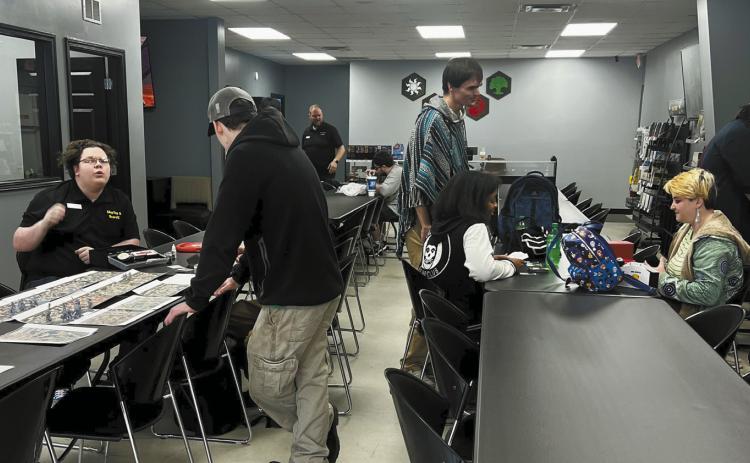 Tables and chairs are set up in the room to give customers plenty of space to play the various games.