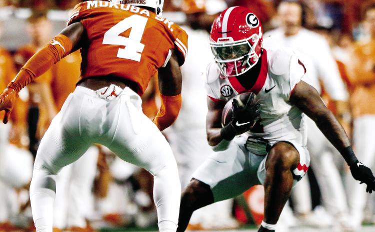 Georgia running back Trevor Etienne (1) accounted for all three Bulldog touchdowns in Austin. LANCE McCURLEY/Staff